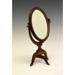 19th Century mahogany and string inlaid oval travelling mirror with swivel base, 31.5cm high overall