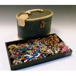 Oval vanity case containing a selection of costume and dress jewellery to include; bead necklaces,