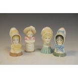 Four Royal Worcester candle snuffers comprising old woman, young girl, mobcap and feathered hat