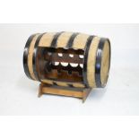 Novelty wine rack formed from a metal-bound barrel, 88cm wide x 66cm high