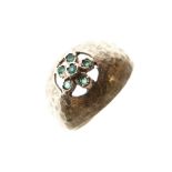 Yellow metal and green stone dress ring of flowerhead design, shank stamped 14k, size K, 2.9g
