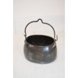 19th Century oval copper vessel having heavy iron loop handle, the pot of dove tail construction,