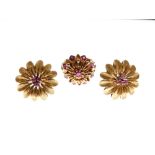 Pair of yellow metal ear studs of flowerhead design with ruby-coloured red stone centres, stamped