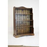 Stained pine bookcase of waterfall design, 80cm wide x 118cm high