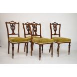 Set of four Victorian walnut dining chairs having stuff-over seats