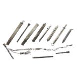 Eleven assorted silver and white metal pencils, retractable and enclosed examples, one with chain