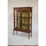 Edwardian mahogany and string inlaid display cabinet fitted two shelves enclosed by a pair of glazed