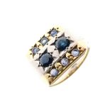 Gentleman's yellow metal and sapphire dress ring, the rectangular panel set with two larger and