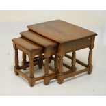 Nest of three elm tables attributed to Ercol, largest 62cm wide
