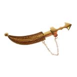 Unmarked yellow metal bar brooch in the form of a Middle Eastern dagger (Jambiya) with filigree