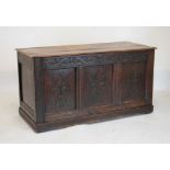 18th/19th Century oak coffer having fleur-de-lys carved triple fielded panelled front with hinged