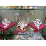 Three German porcelain wall brackets to include a pair, each with plush backing, together with a