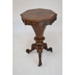 Victorian rosewood octagonal hinged top lady's work table having papered partitioned interior, on