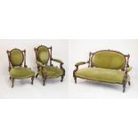 Late Victorian walnut drawing room suite comprising: oval back open arm settee, the scroll arms