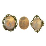 Two gilt metal shell cameo brooches, each depicting figures in landscapes, the larger 48mm x 35mm