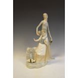 Nao figure of a maid collection water, 40cm high, together with a figure of a girl at a well, 29cm