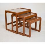 Nest of three retro teak-effect tables with glazed inset tops