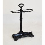 Victorian-style black-painted metal two-division stickstand with drip tray, 71cm high