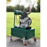1942 Norman single cylinder petrol stationary engine type SC on a green metal trolley, together with