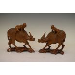 Pair of carved wooden Chinese buffalo, each carrying a child, 16cm high