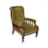 Victorian walnut open arm library chair having acanthus carved scroll arms, turned front supports
