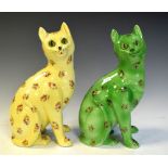 Two porcelain cats, one in yellow the other in green, both having floral decoration, 33cm high