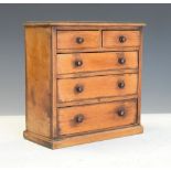 Mahogany miniature chest of drawers fitted with three long drawers and two short drawers, 21cm x