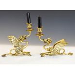 Pair of brass gryphon candlesticks stamped JJ to base of tail, 19.5cm high