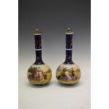 Pair of Austrian bottle shaped transfer printed vases and covers decorated with classical scenes,