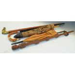 Greyhound handled walking stick, together with a selection of various sticks, an umbrella and a