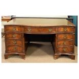 Reproduction Georgian style mahogany serpentine front twin pedestal desk, fitted nine drawers with