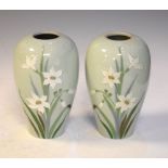 Pair of Gebruder Heubach Pate-sur-Pate vases, decorated with daffodils, marked to base, 16cm high