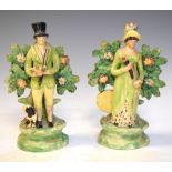 Pair of 18th/19th Staffordshire figures of a lady and gentleman hunting, with bocage background,