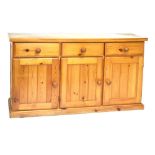 Pine dresser base fitted three drawers over three cupboard doors, 138cm wide