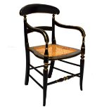 Regency style ebonised and gilt decorated cane seat bar back elbow chair