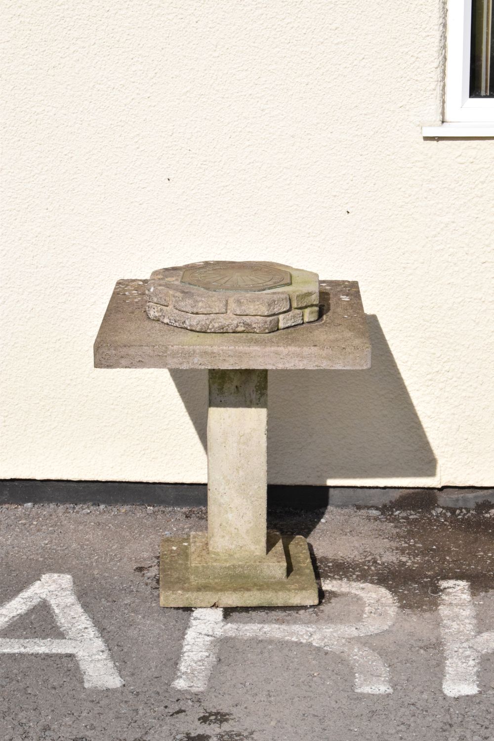 Sundial on a composite stone plinth