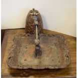 Serpentine dome shaped doorstop and a cast iron bookrack