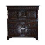 Antique oak heavily carved court cupboard fitted two geometric carved panel doors, the base with a