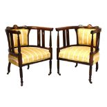 Pair of Edwardian stained beech and bone inlaid open arm tub shaped chairs on reeded front supports