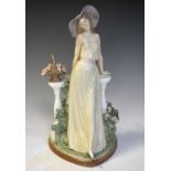 Lladro porcelain figure of a woman leaning against a balcony with basket of flowers (with box), 32cm