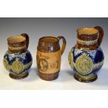 Two Doulton Lambeth Queen Victoria Diamond Jubilee jugs, together with a stoneware example,