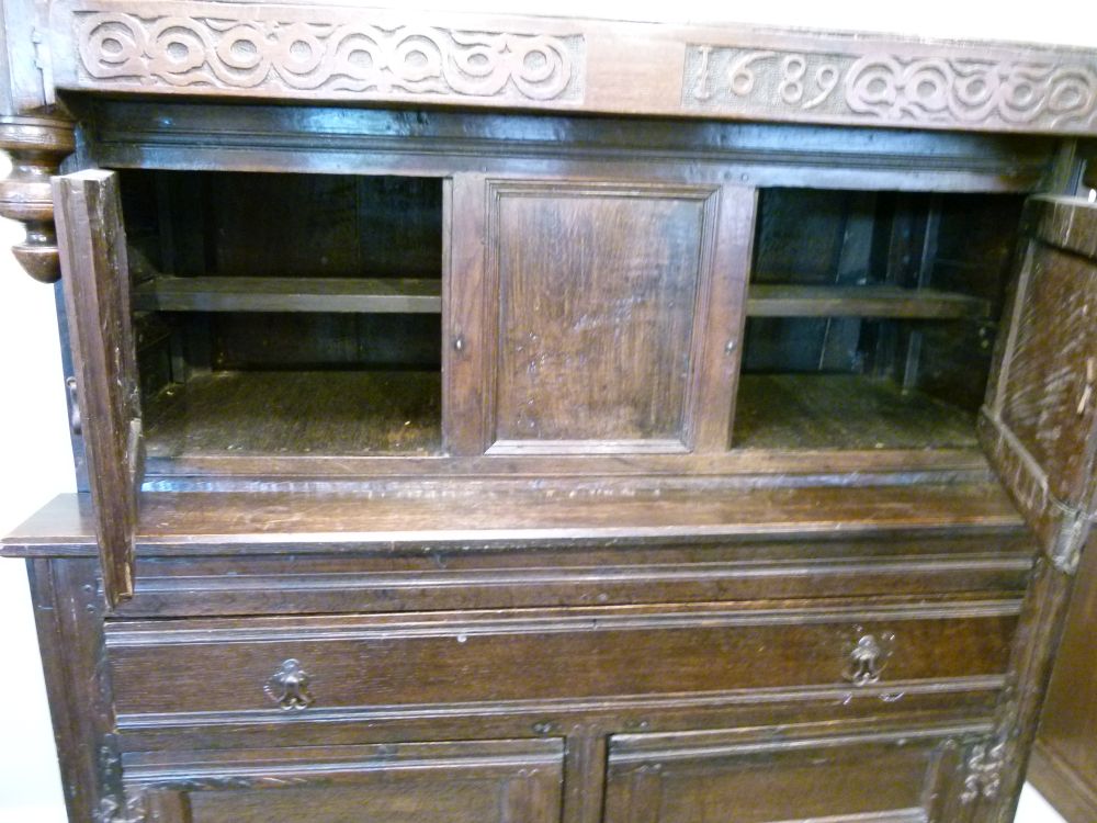 Antique oak heavily carved court cupboard fitted two geometric carved panel doors, the base with a - Image 6 of 10