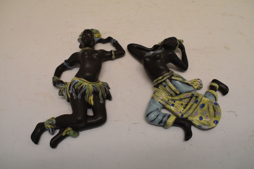 Pair of German pottery dancing figural wall plaques, 24cm high