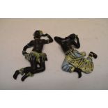 Pair of German pottery dancing figural wall plaques, 24cm high