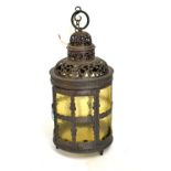 Cylindrical copper finish lantern having pierced decoration and yellow glass shade, 54cm high