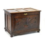 18th/19th Century oak chest having single carved fielded panel front and hinged cover, 110cm wide