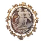 Unmarked yellow metal shell cameo brooch, relief-carved as Cupid and Psyche, with glazed reverse,
