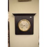 Early 20th Century aneroid barometer in oak surround, 33cm high