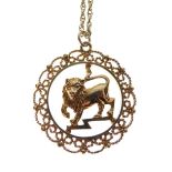 Unmarked yellow metal pendant, possibly Indian, depicting a lion within filigree border, together