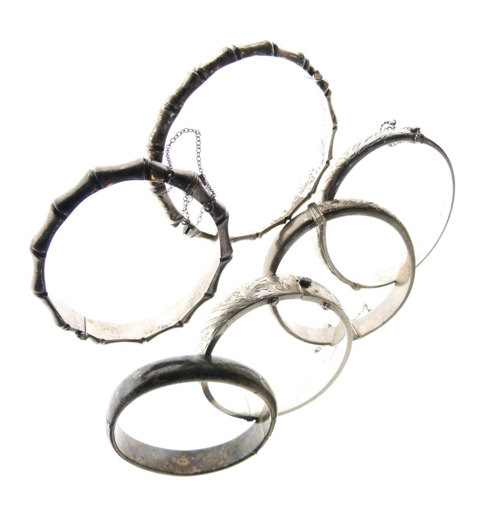 Six assorted silver and white metal snap bangles to include; two of simulated bamboo design, 3.